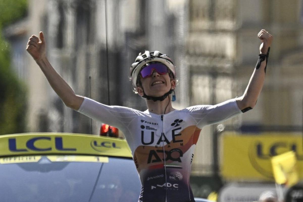 UAE Team ADQ's French rider Maeva Squiban celebrates as she crosses the finish line to win the 6th stage (out of 9) of the fourth edition of the Women's Tour de France cycling race, 123.7 km from Clermont-Ferrand to Ambert, in Ambert, central France on July 31, 2025.  JULIEN DE ROSA / AFP
