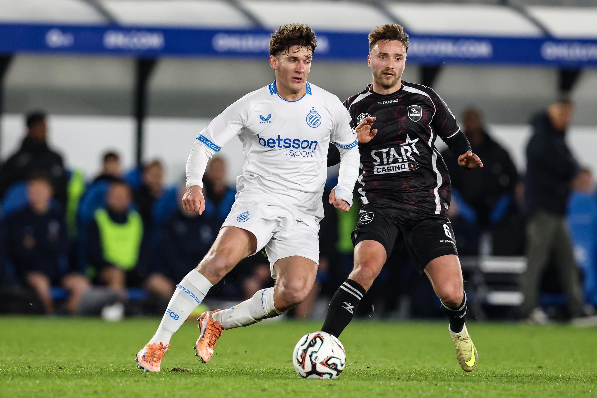 Club's Christos Tzolis and OHL's Wouter George fight for the ball during a soccer game between Oud-Heverlee Leuven and Club Brugge KV, in the 1/8 final of the Croky Cup Belgian cup, Wednesday 03 December 2025 in Leuven. BELGA PHOTO BRUNO FAHY