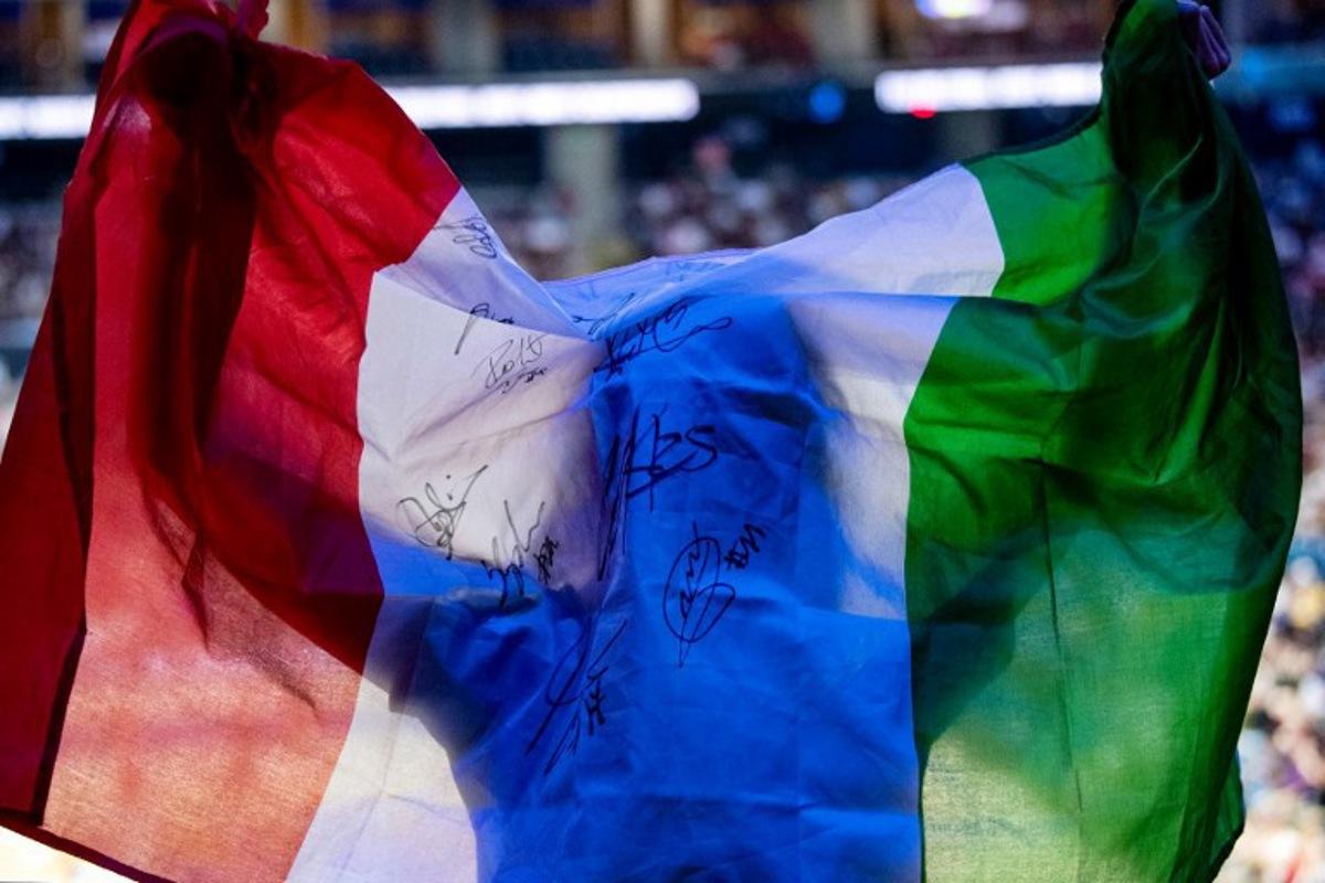 An Italian fan displays a national flag during the 2025 Men's Volleyball World Championship semi-final match between Italy and Poland at the Mall of Asia Arena in Pasay City, Metro Manila on September 27, 2025.  Ted ALJIBE / AFP