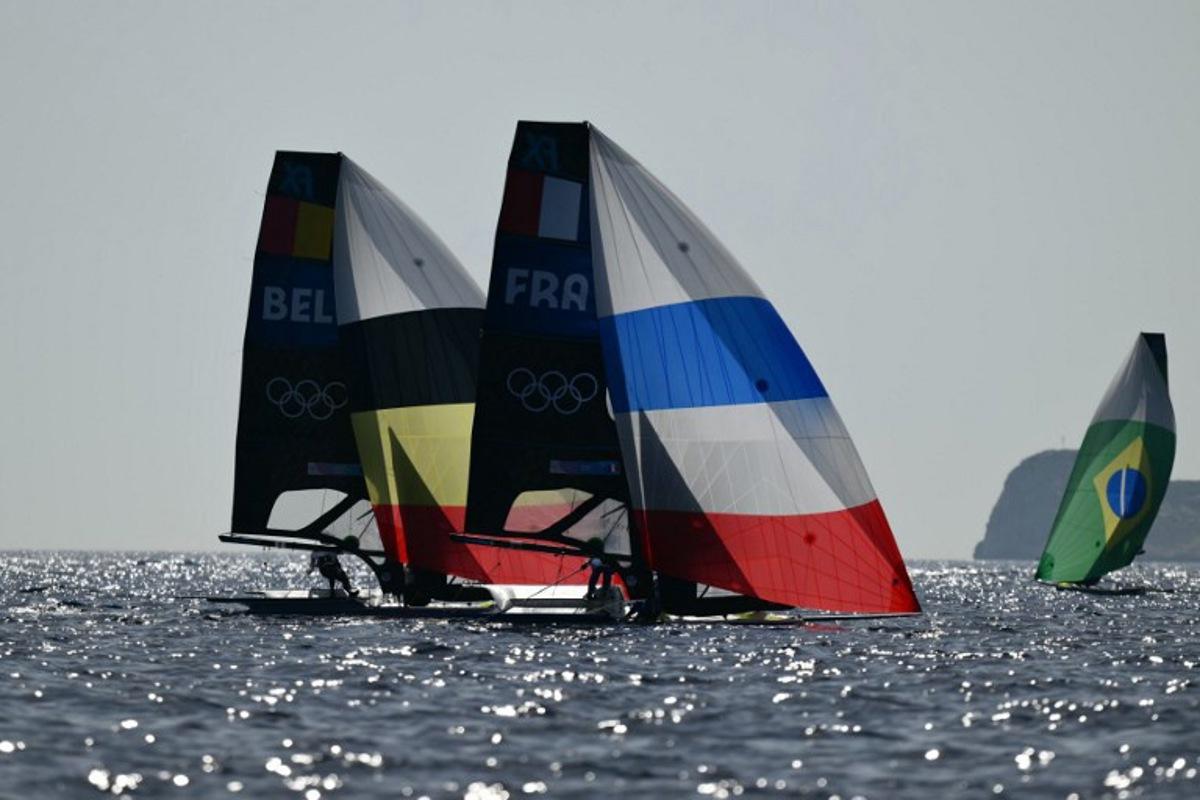 France's duo Sarah Steyaert and Charline Picon and Belgium's duo Isaura Maenhaut and Anouk Geurts compete in Race 6 of the women's 49erFX skiff event during the Paris 2024 Olympic Games sailing competition at Marseille's Marina on July 29, 2024.   Christophe SIMON / AFP