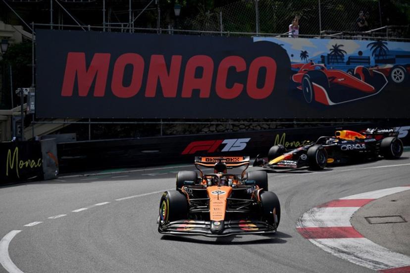 McLaren's Australian driver Oscar Piastri (C) races ahead of Red Bull Racing's Dutch driver Max Verstappen (R) during the Formula One Monaco Grand Prix at the Circuit de Monaco, on May 25, 2025.  Christophe Simon / AFP