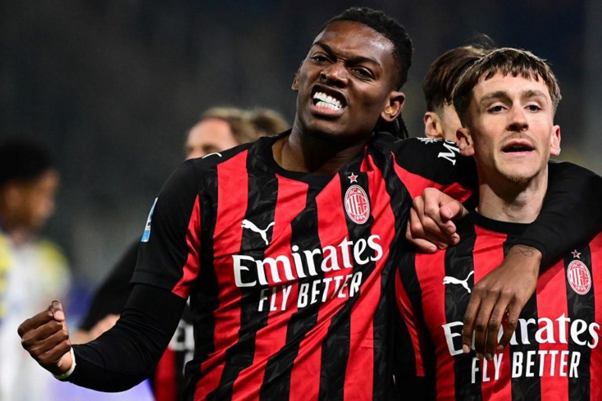 AC Milan's Belgian midfielder #56 Alexis Saelemaekers (R) celebrates with AC Milan's Portuguese forward #10 Rafael Leao after scoring his team first goal during the Italian Serie A football match between Parma and AC Milan at the San Siro Stadium in Parma, northern Italy, on November 8, 2025. Piero CRUCIATTI / AFP