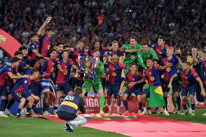 Barcelona's players celebrate their 28th Liga title after the Spanish league football match between FC Barcelona and Villarreal CF at Estadi Olimpic Lluis Companys in Barcelona on May 18, 2025. MANAURE QUINTERO / AFP