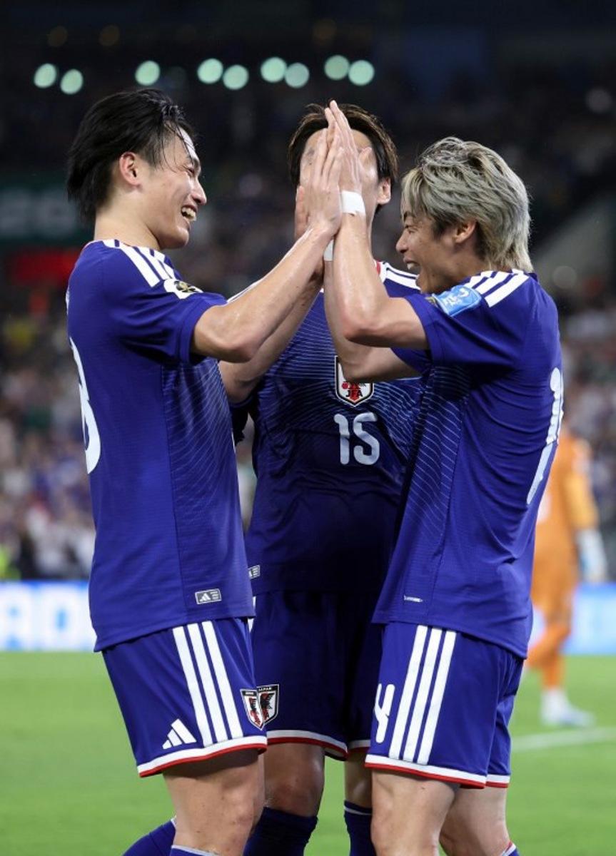 Japan's midfielder #14 Junya Ito (R) celebrates with Japan's forward #18 Ayase Ueda and Japan's midfielder #15 Daichi Kamada after scoring his team third goal during the 2026 World Cup Group F football match between Tunisia and Japan at the Monterrey Stadium in Guadalupe, Mexico, on June 20, 2026. Julio Cesar AGUILAR / AFP