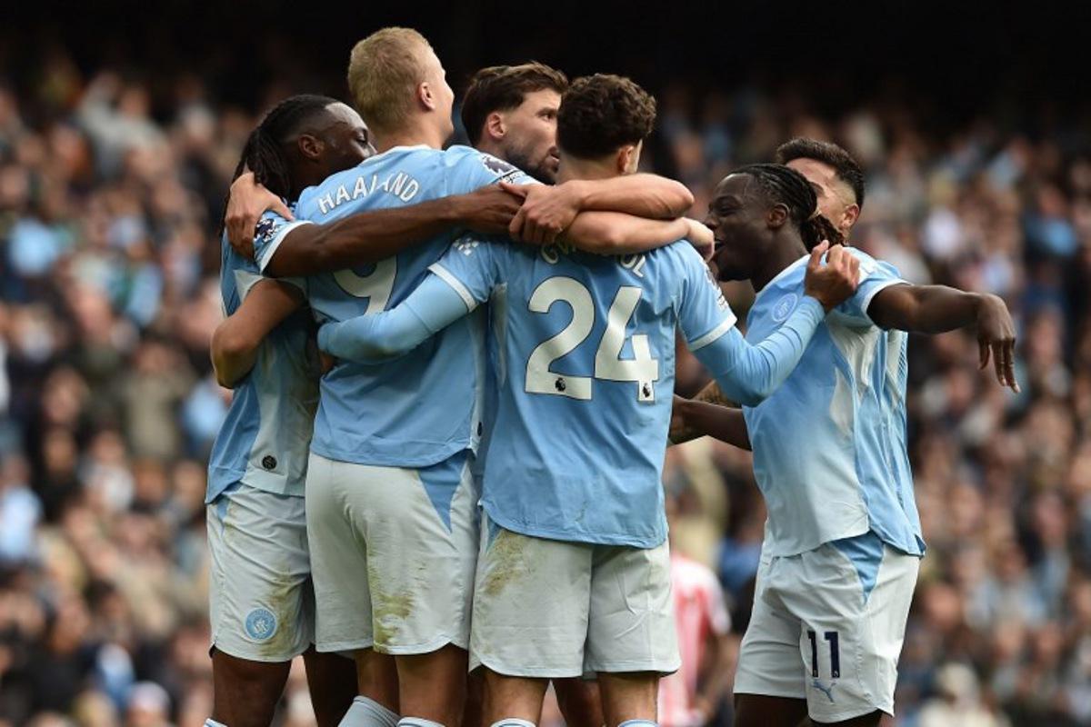 Manchester City's Norwegian striker #09 Erling Haaland (2L) celebrates with teammates after scoring their fifth goal during the English Premier League football match between Manchester City and Sunderland at the Etihad Stadium in Manchester, north west England, on September 20, 2026. PETER POWELL / AFP