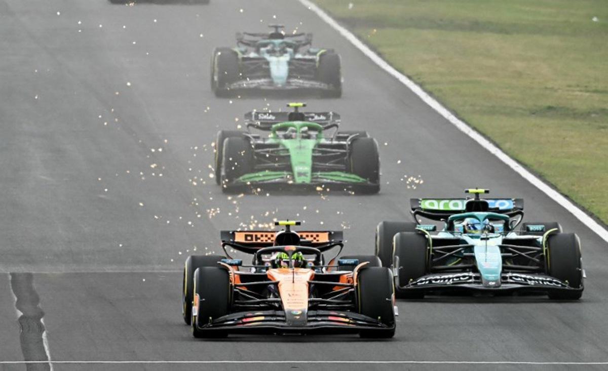 McLaren's British driver Lando Norris (L) and Aston Martin's Spanish driver Fernando Alonso (R) compete during the Formula One Hungarian Grand Prix at the Hungaroring circuit in Mogyorod near Budapest, Hungary, on August 3, 2025. Attila KISBENEDEK / AFP