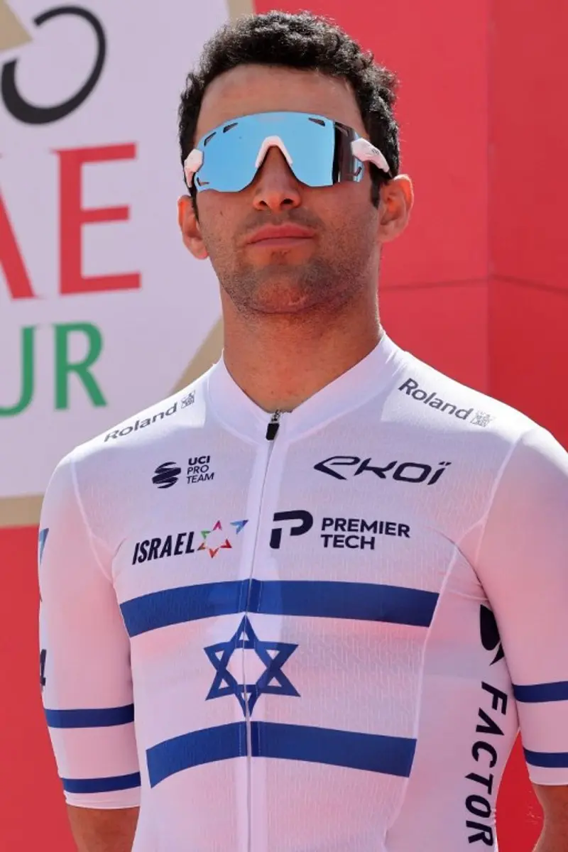 Israeli cyclist Itamar Einhorn of the Israel-Premier Tech Team poses for a photo before the start of the first stage of the UAE cycling tour from al-Dhafra Castle to Qassar al-Mighayra St in al-Mirfa in the emirate of Abu Dhabi on February 20, 2023. Giuseppe CACACE / AFP