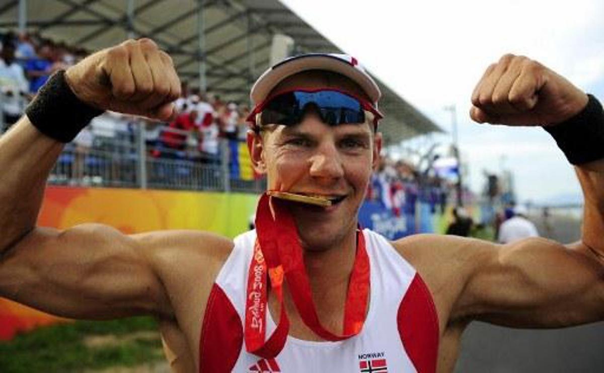 Norway's Olaf Tufte strikes a pose with his gold meda following the medals during the medal ceremony for the men's pair final at the Shunyi Rowing and Canoeing Park during the 2008 Beijing Olympic Games in Beijing on August 16, 2008. Norway won gold, Czech Republic Silver and New Zealand bronze. AFP PHOTO / FRED DUFOUR