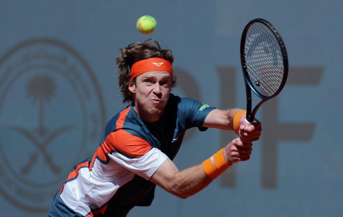 Russia's Andrey Rublev plays a return against Kazakstan's Alexander Bublik during their 2025 ATP Tour Madrid Open tennis tournament third round singles match at the Caja Magica in Madrid, on April 27, 2025. Thomas COEX / AFP