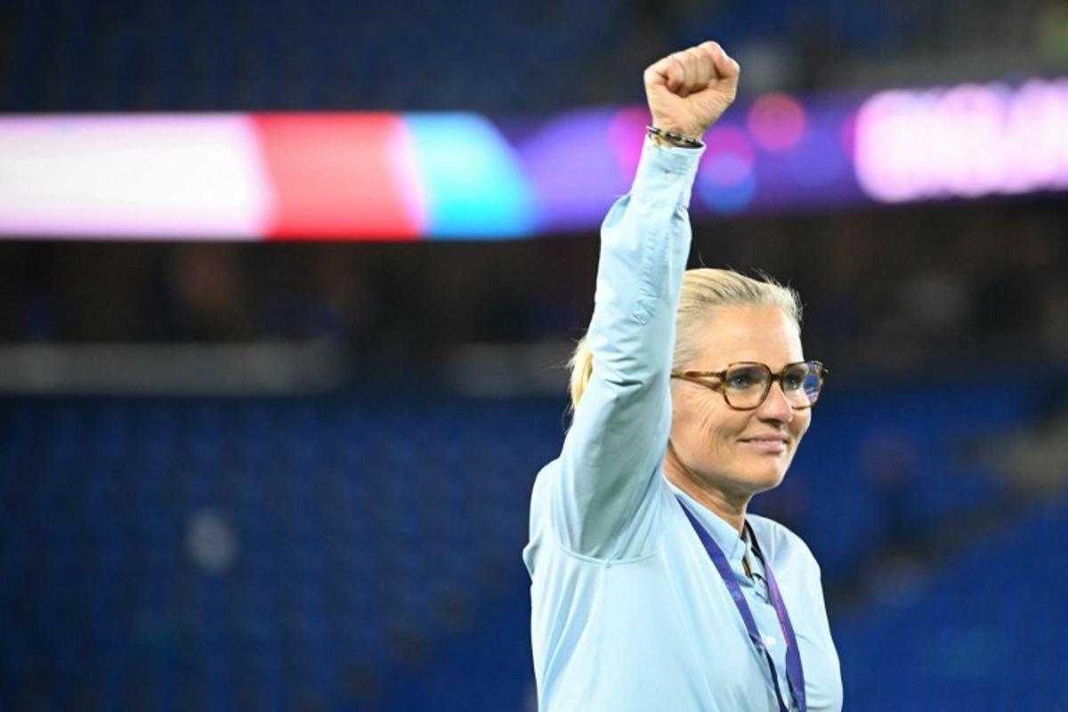 England's Dutch coach Sarina Wiegman punches the air after England won the UEFA Women's Euro 2025 final football match between England and Spain at the St. Jakob-Park Stadium in Basel, on July 27, 2025. England beat Spain 3-1 on penalties to win the Women's Euro 2025 final. SEBASTIEN BOZON / AFP