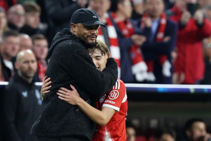 Bayern Munich's Belgian head coach Vincent Kompany (L) reacts with Bayern Munich's German midfielder #42 Lennart Karl after Karl left the pitch during the UEFA Champions League football match between FC Bayern Munich and Club Brugge in Munich, southern Germany on October 22, 2025. Alexandra BEIER / AFP
