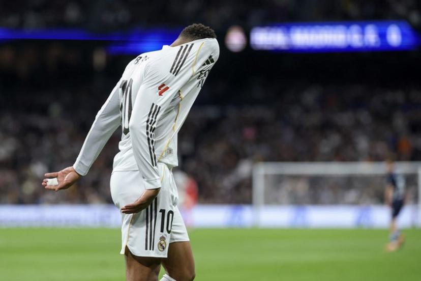 Real Madrid's French forward #10 Kylian Mbappe reacts with his head in his jersey during the Spanish league football match between Real Madrid CF and RC Celta de Vigo at the Santiago Bernabeu Stadium in Madrid on December 7, 2025. Thomas COEX / AFP