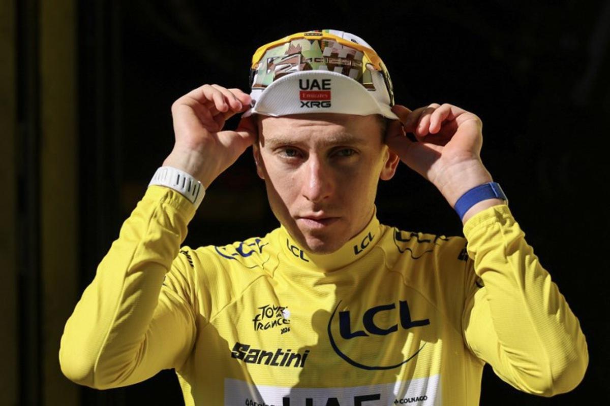 UAE Team Emirates - XRG's Slovenian rider Tadej Pogacar celebrates on the podium with the overall leader's yellow jersey after the 17th stage of the 113th edition of the Tour de France cycling race, 174,7 km between Chambéry and Voiron in the French Alps, on July 22, 2026. Anne-Christine POUJOULAT / AFP