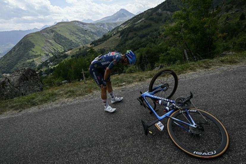 Soudal Quick-Step team's Belgian rider Ilan Van Wilder awaits technical assistance on the roadside during the 20th stage of the 113th edition of the Tour de France cycling race, 170,9 km between Le Bourg-d'Oisans and Alpe d'Huez in the French Alps, on July 25, 2026. Loic VENANCE / AFP