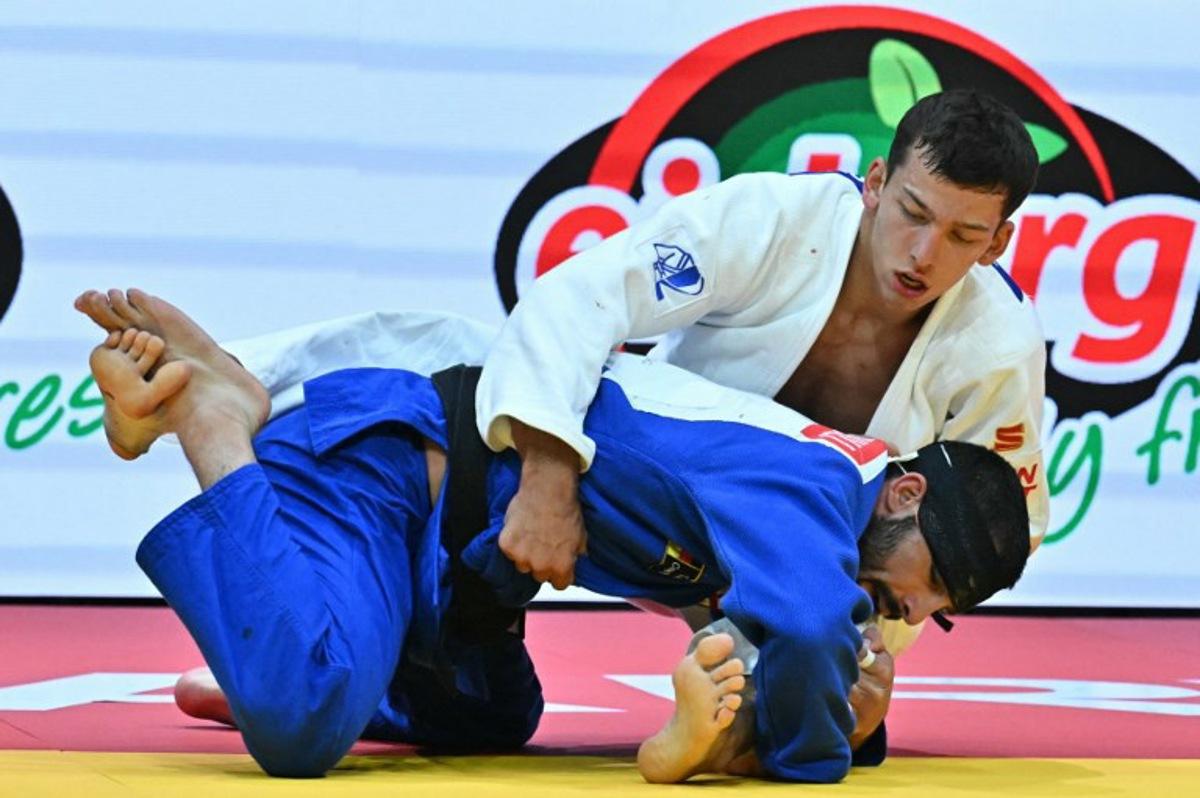 Georgia's Tato Grigalashvili competes against International Judo Federation's Timur Arbuzov in the men's -81kg final of the Judo World Championships at Papp Laszlo Arena in Budapest, Hungary, on June 16, 2025. Attila KISBENEDEK / AFP