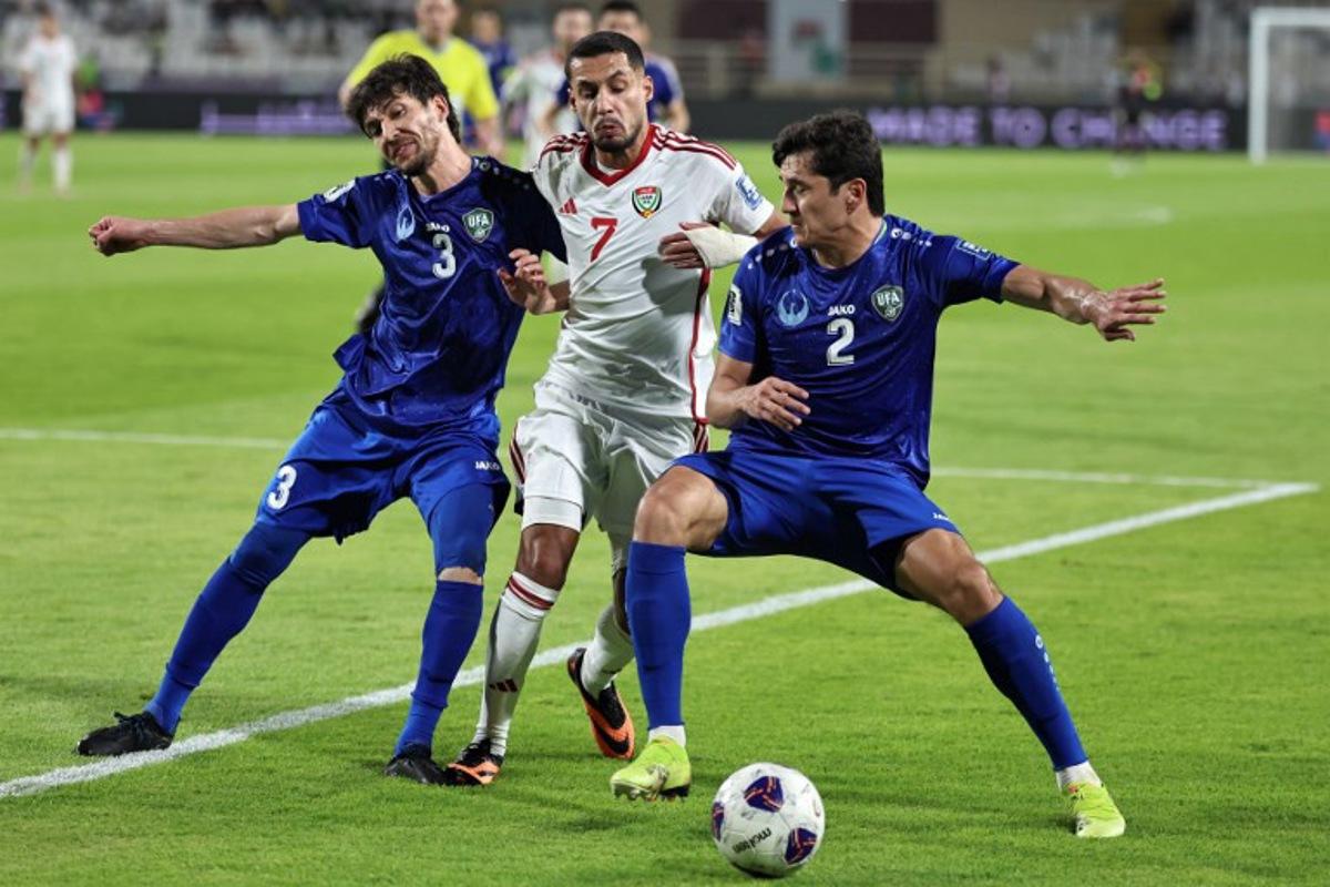 Uzbekistan's defender #3 Khojiakbar Alijonov and defender #2 Abdukodir Khusanov vie for the ball against UAE's forward #7 Ali Saleh during the 2026 FIFA World Cup Asian Qualifier football match between the United Arab Emirates and Uzbekistan at Al-Nahyan Stadium in Abu Dhabi on June 5, 2025. Fadel SENNA / AFP