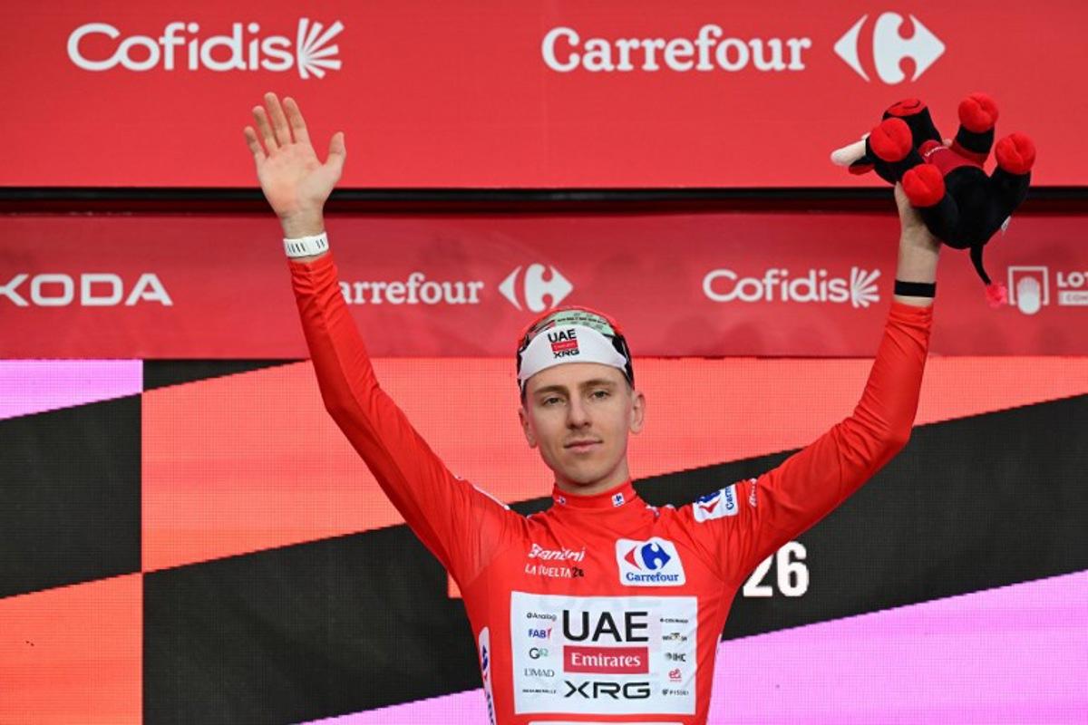 UAE Team Emirates - XRG team's Slovenian rider Tadej Pogacar celebrates on the podium wearing the overall leader's red jersey, after winning the first stage of the Vuelta a Espana 2026, a 9,4 km time-trial between Monaco and Monaco on August 22, 2026. Miguel MEDINA / AFP