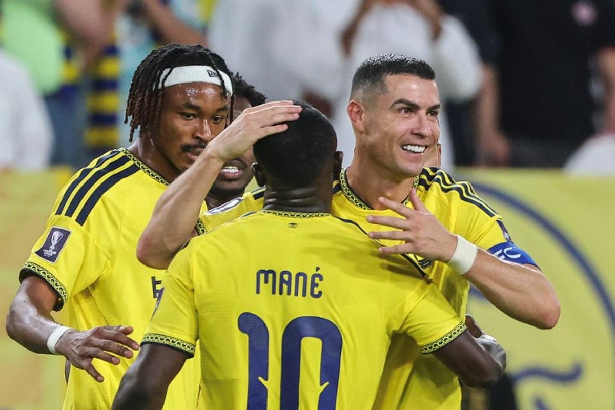 Nassr's Portuguese forward #07 Cristiano Ronaldo celebrates with Nassr's Senegalese Forward #10 Sadio Mane after scoring his team's second goal during the AFC Champions League group B football match between Al-Nassr and Neftchi Fergana at the Alawwal Park stadium in Riyadh on October 12, 2026. Fayez NURELDINE / AFP