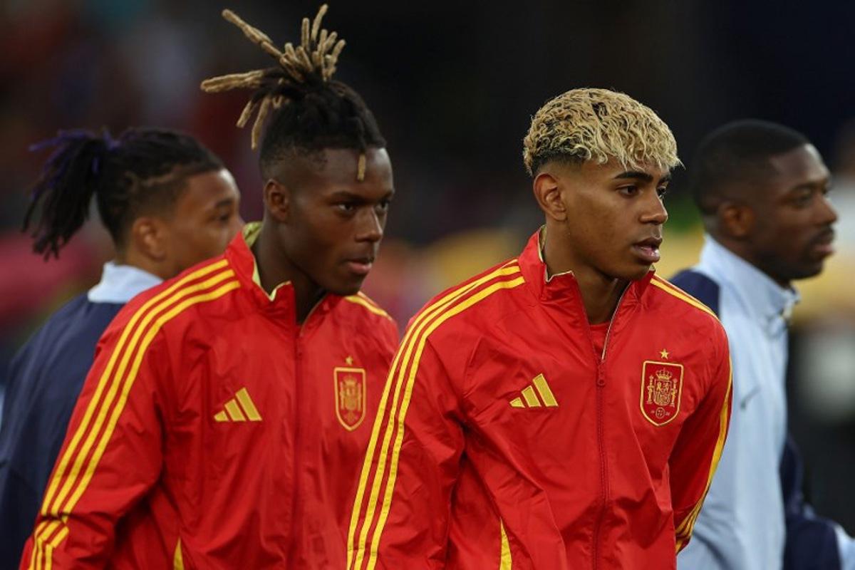 Spain's forward #19 Lamine Yamal (R) and Spain's forward #11 Nico Williams (L) walk on to the pitch prior to the UEFA Nations League semi-final football match between Spain and France in Stuttgart, southwestern Germany, on June 5, 2025. FRANCK FIFE / AFP