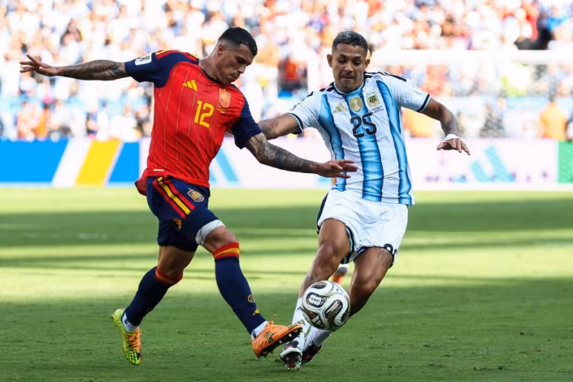 Spain's defender #12 Pedro Porro and Argentina's defender #25 Facundo Medina fight for the ball during the 2026 World Cup football tournament final match between Spain and Argentina at the New York/New Jersey Stadium in East Rutherford on July 19, 2026. FRANCK FIFE / AFP