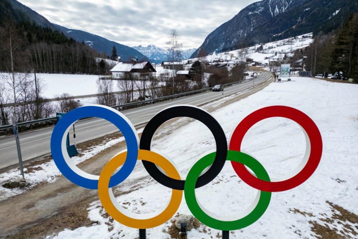 The Olympic rings are seen along a road leading to the Biathlon venue in Antholz, northern Italy, prior to the Milano Cortina 2026 Olympic Games, on January 23, 2026. Odd ANDERSEN / AFP