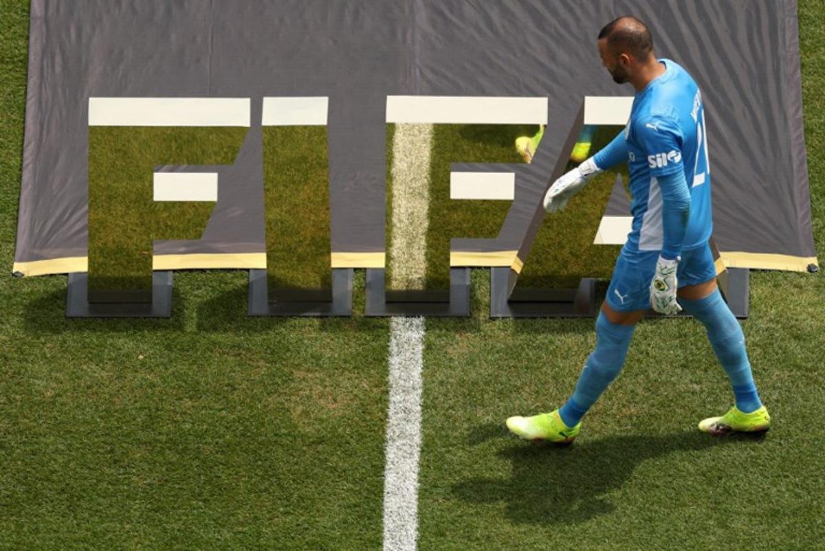 Palmeiras' Brazilian goalkeeper #21 Weverton walks in front of a FIFA logo ahead of the FIFA Club World Cup 2025 round of 16 all-Brazilian football match between Palmeiras and Botafogo at Lincoln Financial Field Stadium in Philadelphia on June 28, 2025. CHARLY TRIBALLEAU / AFP