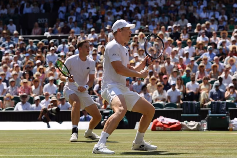 Britain's Henry Patten and Finland's Harri Heliovaara wait for a return from El Salvador's Marcelo Arevalo and Croatia's Mate Pavic during their men's doubles final tennis match on the thirteenth day of the 2026 Wimbledon Championships at The All England Lawn Tennis and Croquet Club in Wimbledon, southwest London, on July 11, 2026. Adrian Dennis / AFP