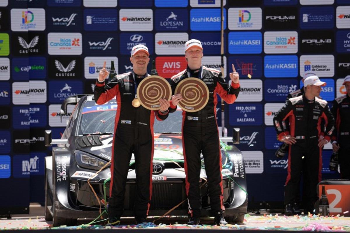 Kalle Rovanpera of Finland (R) and his co-driver Jonne Halttunen of Finland from the team Toyota Gazoo Racing WRT hold their trophies as they celebrate after winning the World Rally Championship (WRC) Rally Islas Canarias on the island of Gran Canaria in Spain's Canary Islands, on April 27, 2025. Manaure QUINTERO / AFP