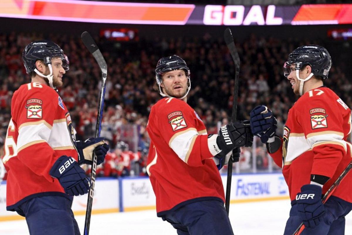 (L to R) Aleksander Barkov, Dmitry Kulikov and Evan Rodrigues of Florida celebrate the opening 0-1 goal by Rodrigues during the NHL Global Series Ice Hockey match Dallas Stars vs Florida Panthers in Tampere, Finland on November 2, 2024. Heikki Saukkomaa / Lehtikuva / AFP