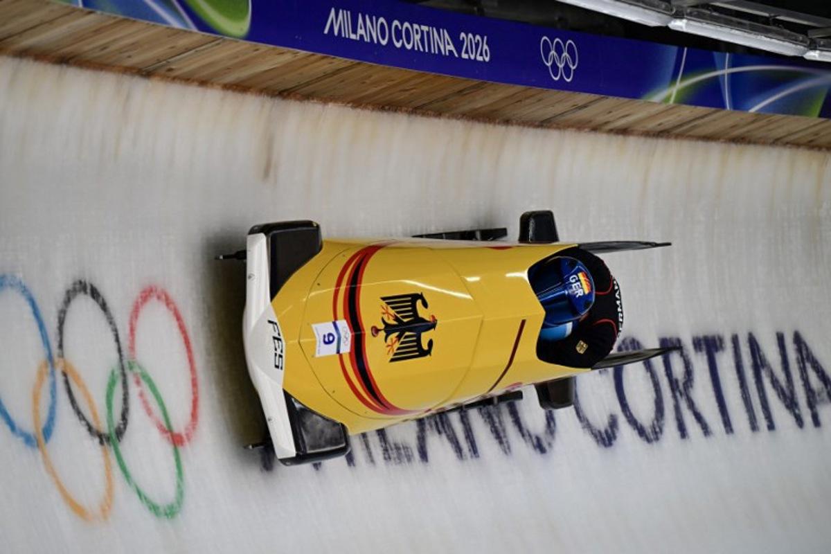 Germany's Johannes Lochner pilots in the bobsleigh men's 2-man training Heat 4 at Cortina Sliding Centre during the Milano Cortina 2026 Winter Olympic Games in Cortina d'Ampezzo on February 13, 2026. Stefano RELLANDINI / AFP