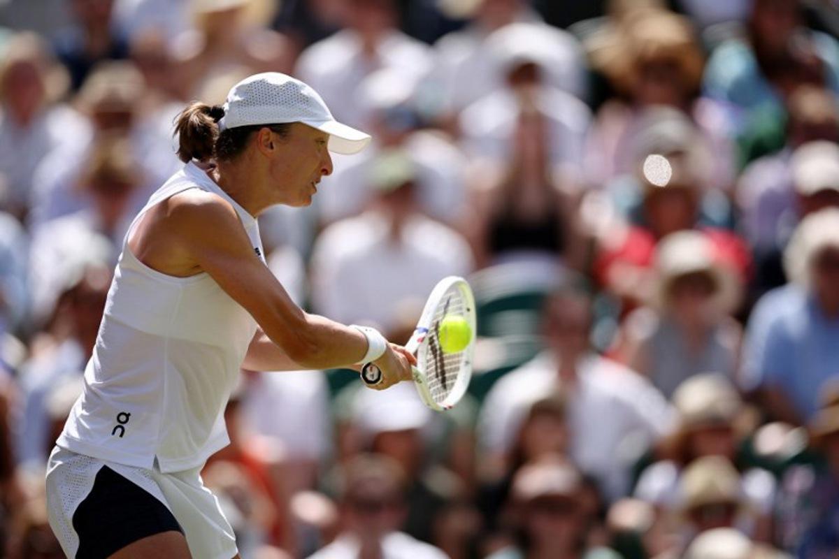 Poland's Iga Swiatek returns to Philippines' Alexandra Eala during their women's singles third round tennis match on the sixth day of the 2026 Wimbledon Championships at The All England Lawn Tennis and Croquet Club in Wimbledon, southwest London, on July 4, 2026. Henry Nicholls / AFP
