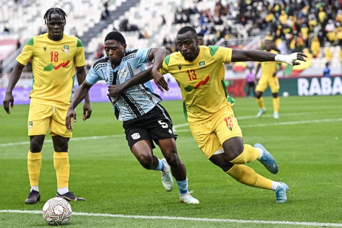 Botswana's defender #05 Alford Velaphi and Benin's defender #13 Mohamed Tijani vie during the Africa Cup of Nations (CAN) Group D football match between Benin and Botswana at Rabat Olympic Stadium in Rabat on December 27, 2025. Paul ELLIS / AFP