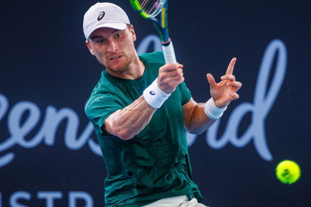 Belgium's Raphael Collignon hits a forehand during the men's singles match against Canada's Denis Shapovalov at the Brisbane International tennis tournament in Patrick Rafter Tennis Centre in Brisbane on January 6, 2026. Patrick HAMILTON / AFP PHOTO / AFP