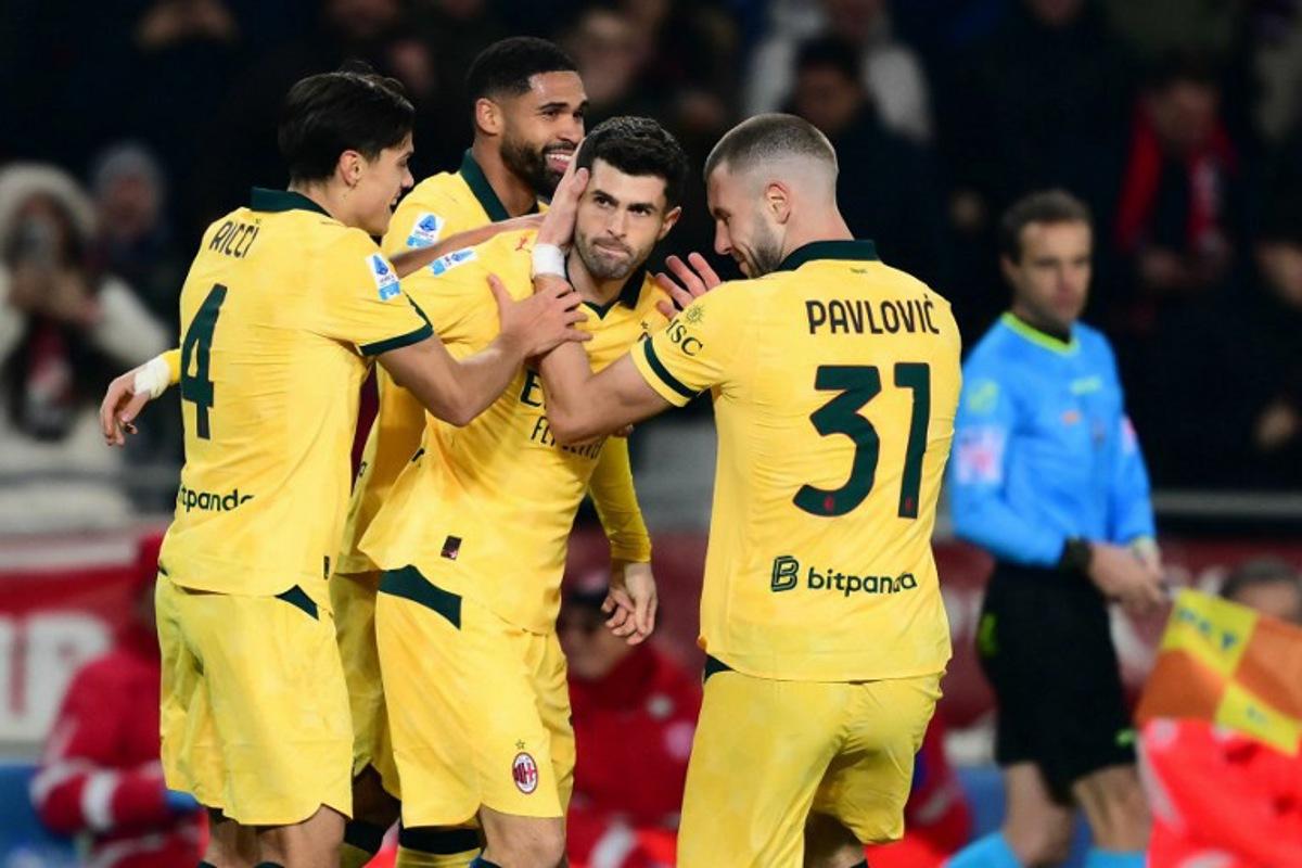 AC Milan's US forward #11 Christian Pulisic (C) celebrates scoring his team's second goal with teammates AC Milan's Italian midfielder #04 Samuele Ricci and AC Milan's Serbian defender #31 Strahinja Pavlovic during the Italian Serie A football match between Torino and AC Milan at the Allianz stadium in Turin, on December 8, 2025. Marco BERTORELLO / AFP