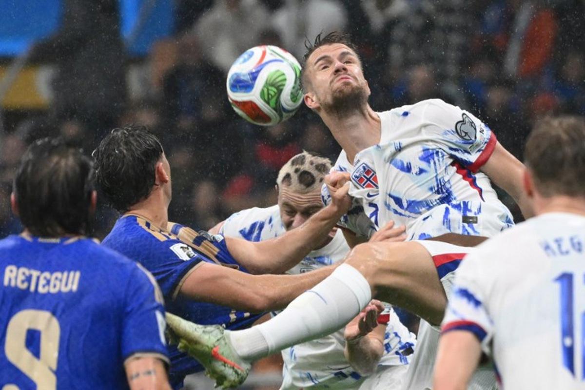 Norway's defender #03 Kristoffer Vassbakk Ajer jumps for the ball during the FIFA World Cup 2026 European qualification football match between Italy and Norway, at the San Siro Stadium, in Milan, on November 16, 2025. Alberto PIZZOLI / AFP