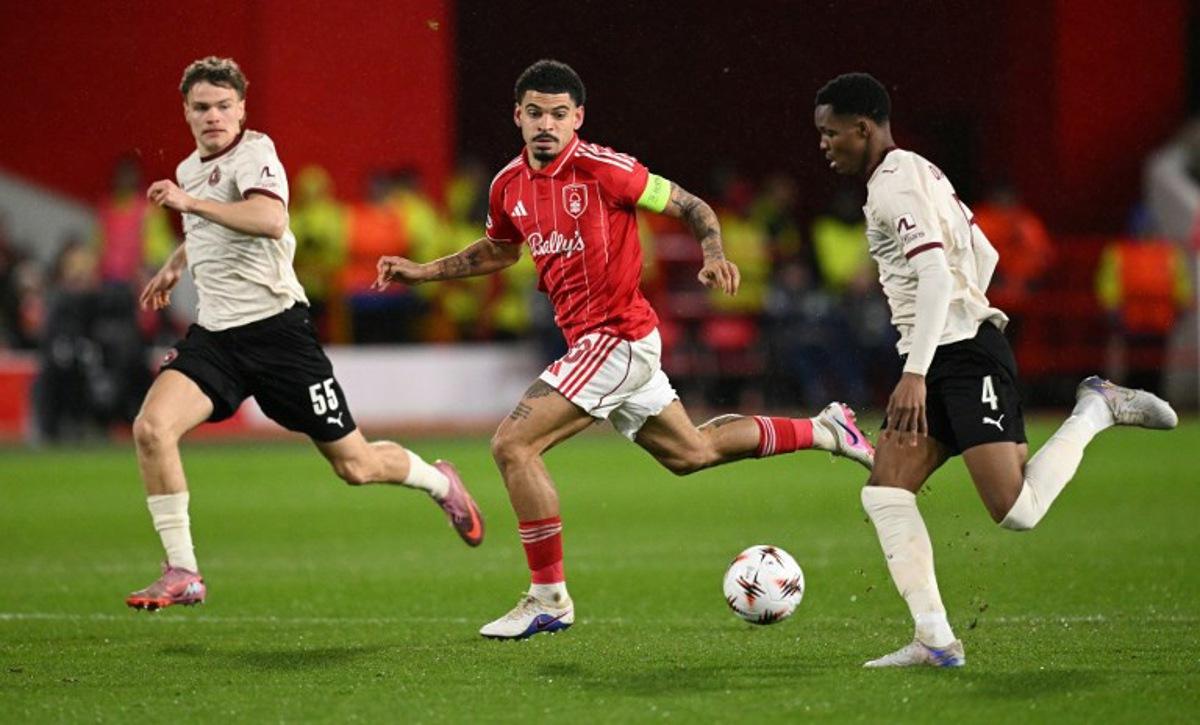 Nottingham Forest's English midfielder #10 Morgan Gibbs-White (C) chases down Midtjylland's Senegalese defender #04 Ousmane Diao (R) during the UEFA Europa League round of 16, first leg football match between Nottingham Forest and FC Midtjylland at The City Ground in Nottingham, central England, on March 12, 2026. Oli SCARFF / AFP