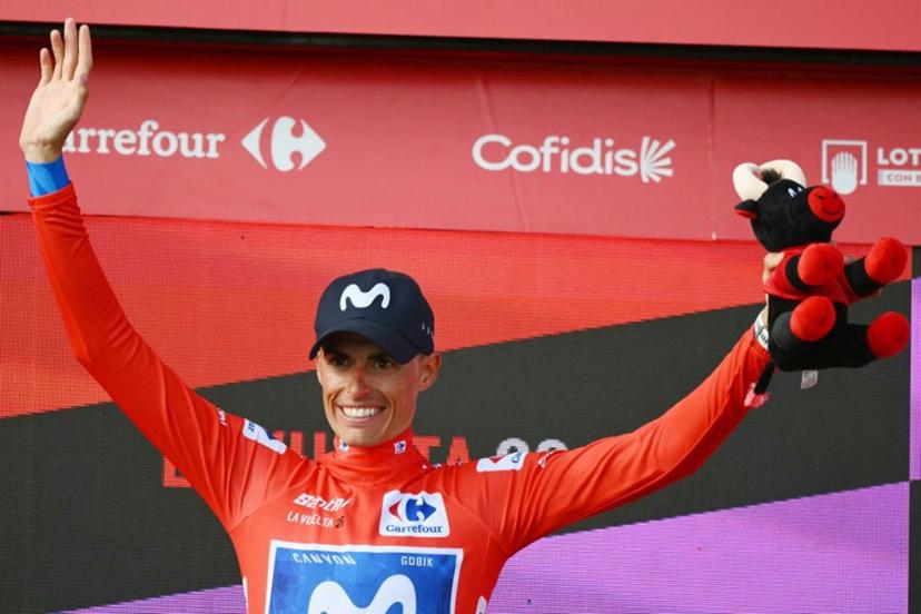 Team Movistar's Spanish rider Enric Mas celebrates on the podium retaining the overall ranking leader's red jersey after the 12th stage of the Vuelta a Espana 2026 cycling tour, a 166,6 km race between Vera and Calar Alto, on September 3, 2026. JOSE JORDAN / AFP