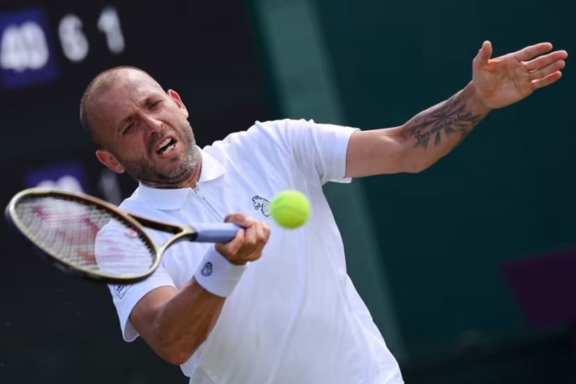 Britain's Daniel Evans plays a forehand return to Britain's Jay Clarke during their men's singles first round tennis match on the second day of the 2025 Wimbledon Championships at The All England Lawn Tennis and Croquet Club in Wimbledon, southwest London, on July 1, 2025. Adrian Dennis / AFP