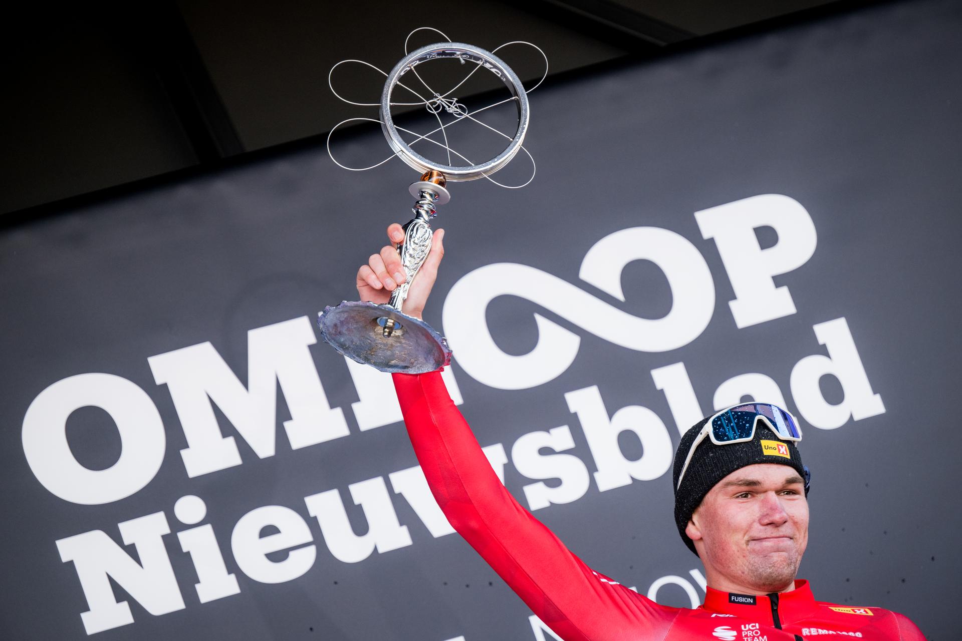 Norwegian Soren Waerenskjold of Uno-X Mobility celebrates on the podium after winning the men's one-day cycling race Omloop Het Nieuwsblad (UCI World Tour), 197 km from Gent to Ninove, Saturday 01 March 2025. BELGA PHOTO JASPER JACOBS