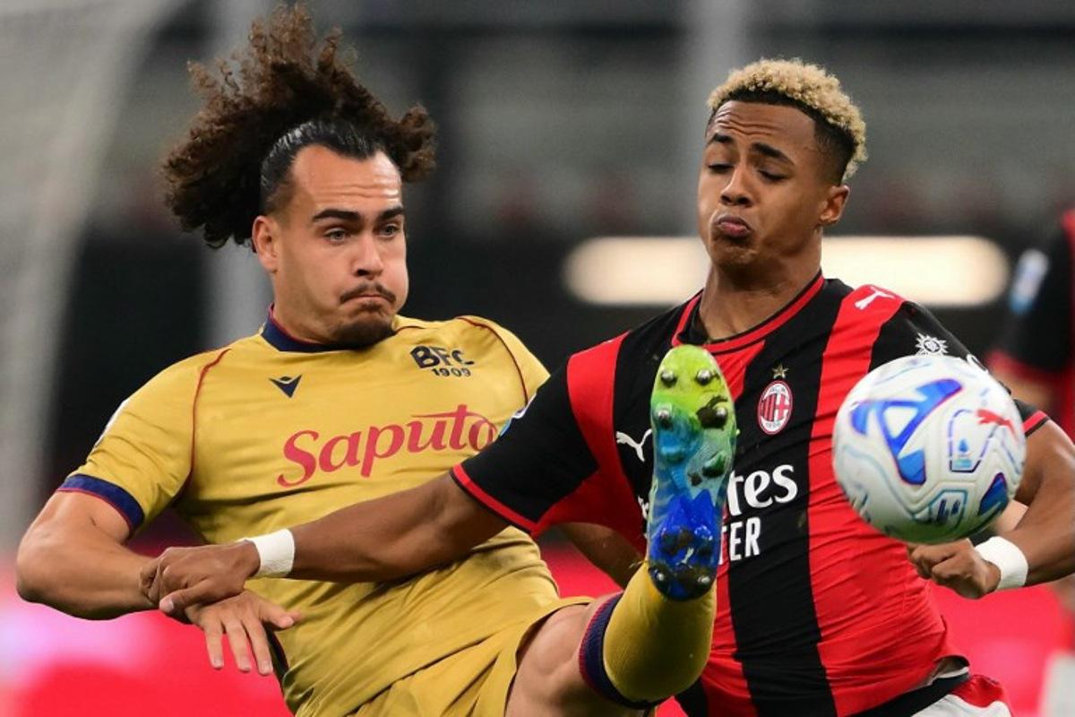 Ac Milan's English midfielder #20 Omari Hutchinson (R) fights for the ball with Bologna's Belgian defender #3 Arthur Theate (L) during the Italian Serie A football match between AC Milan and Bologna at the San Siro stadium in Milan, northern Italy on October 28, 2026. Marco Bertorello / AFP