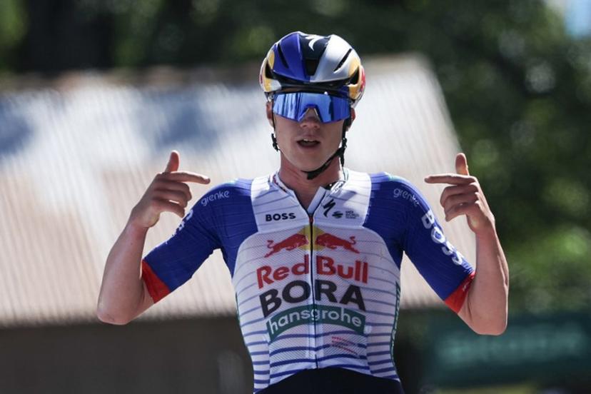 Red Bull - Bora - Hansgrohe's Belgian rider Maxim Van Gils celebrates as he cycles across the finish line to win the 6th stage of the Tour Auvergne-Rhone-Alpes cycling race (formerly known as the Criterium du Dauphine), 182,3km between Saint-Vulbas and Crest-Voland in the French Alps on June 12, 2026. Anne-Christine POUJOULAT / AFP