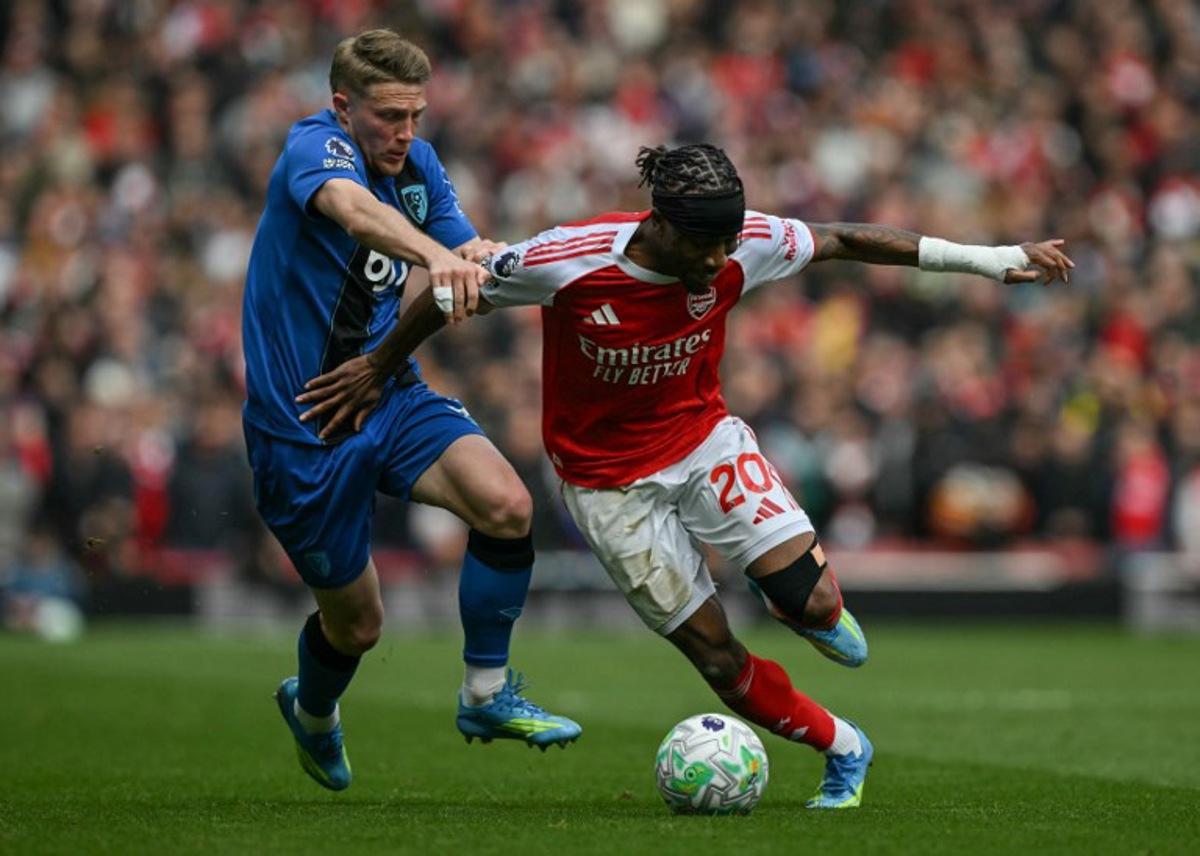 Bournemouth's French defender #03 Adrien Truffert (L) tackles Arsenal's English midfielder #20 Noni Madueke (R) during the English Premier League football match between Arsenal and Bournemouth at the Emirates Stadium in London on April 11, 2026. Glyn KIRK / AFP