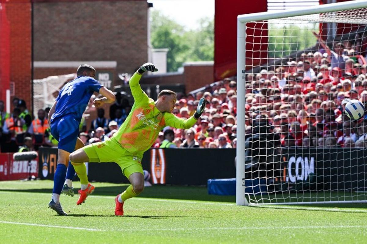 Leicester City's English defender #04 Conor Coady heads the ball and scores his team first goal past Nottingham Forest's Belgian goalkeeper #26 Matz Sels during the English Premier League football match between Nottingham Forest and Leicester City at The City Ground in Nottingham, central England, on May 11, 2025. JUSTIN TALLIS / AFP