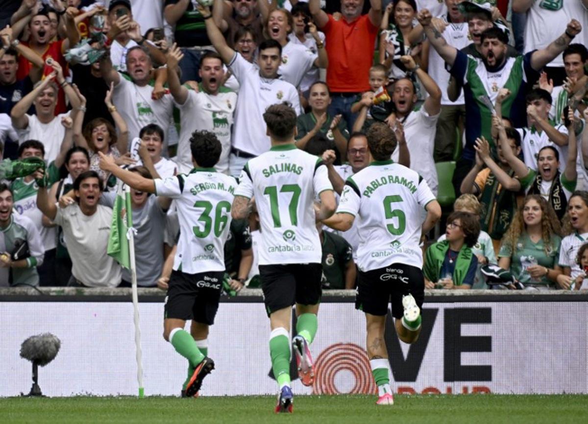 Racing Santander's Spanish midfielder #36 Sergio Martinez Montero celebrates with supporters scoring his team's second goal during the Spanish league football match between Racing Santander and Villarreal in El Sardinero stadium in Santander on August 16, 2026. ANDER GILLENEA / AFP
