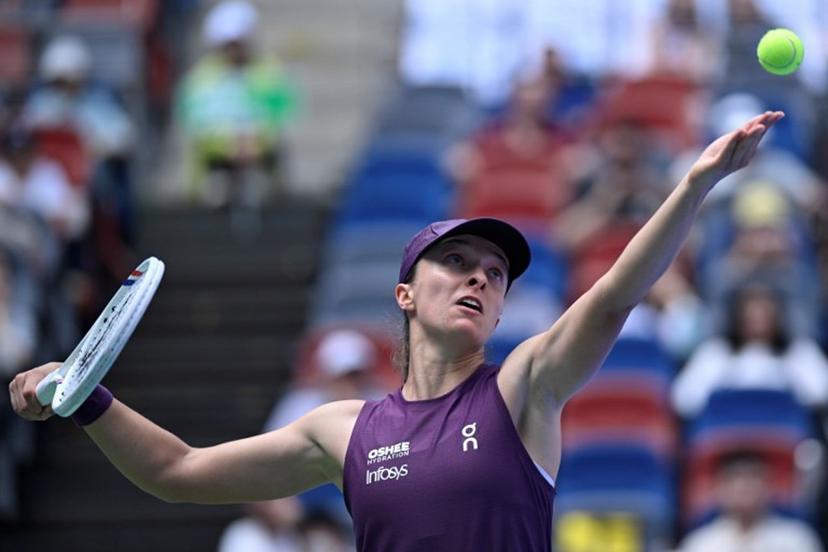 Poland's Iga Swiatek serves to Poland's Magdalena Frech during their women's singles match at the Wuhan Open tennis tournament in Wuhan, China's Hubei province on October 14, 2026. WANG Zhao / AFP