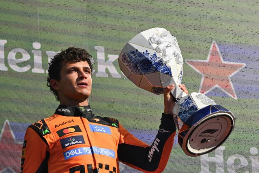 P1 McLaren's British driver Lando Norris celebrates with the trophy on the podium after the Formula One Dutch Grand Prix at The Circuit Zandvoort, western Netherlands, on August 23, 2026. JOHN THYS / AFP