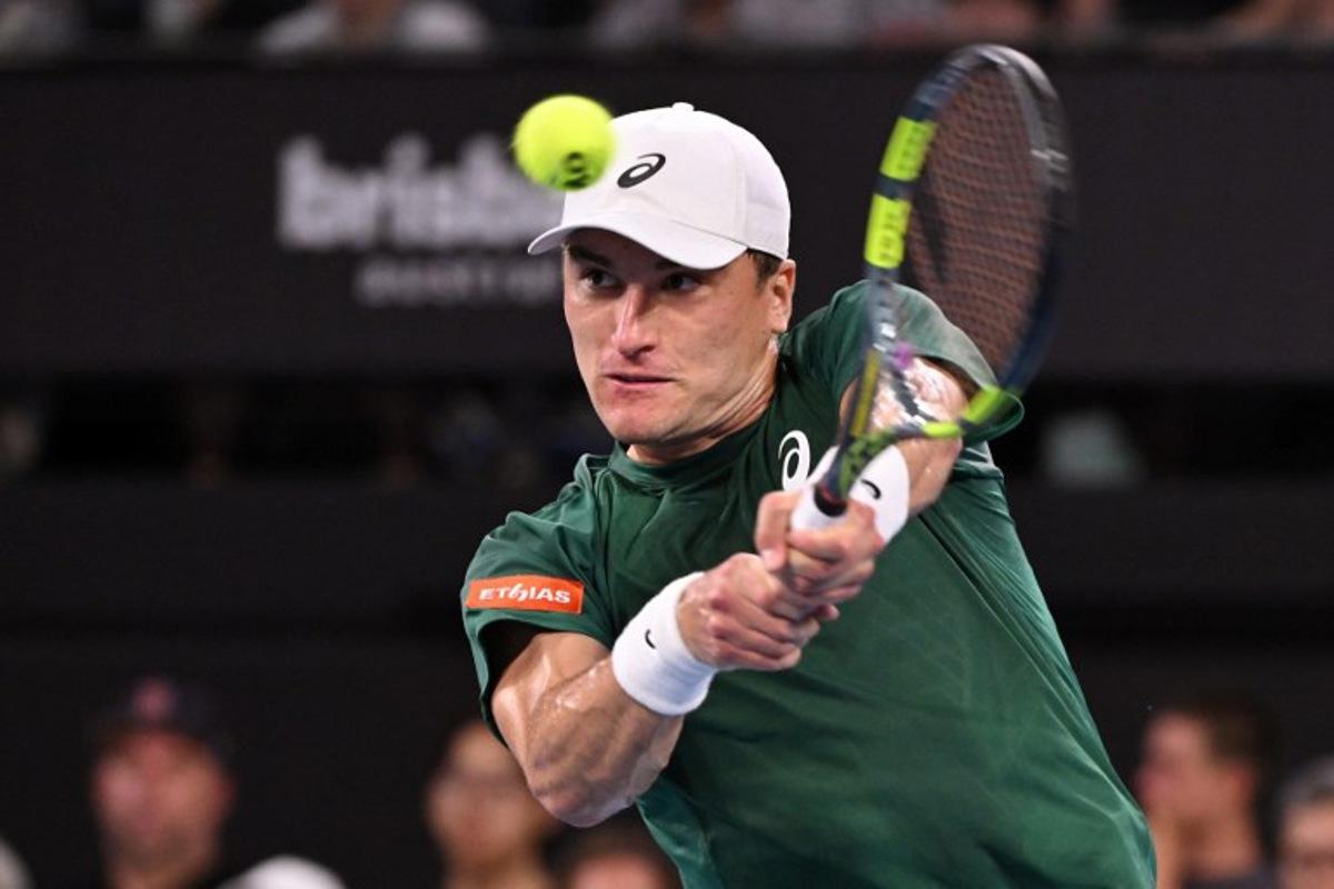 Belgium's Raphael Collignon hits a return to Bulgaria's Grigor Dimitrov during their men's singles match at the Brisbane International tennis tournament in Brisbane on January 8, 2026. William WEST / AFP