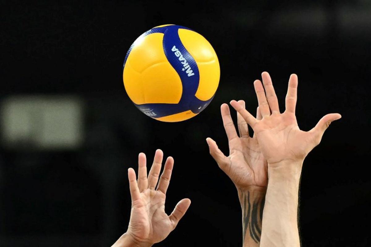 Brazil's #28 Darlan Ferreira Souza (L) and Brazil's #23 Flavio Resende Gualberto try to block the ball with their hands during the volleyball men's quarter-final match between USA and Brazil during the Paris 2024 Olympic Games at the South Paris Arena 1 in Paris on August 5, 2024. Natalia KOLESNIKOVA / AFP