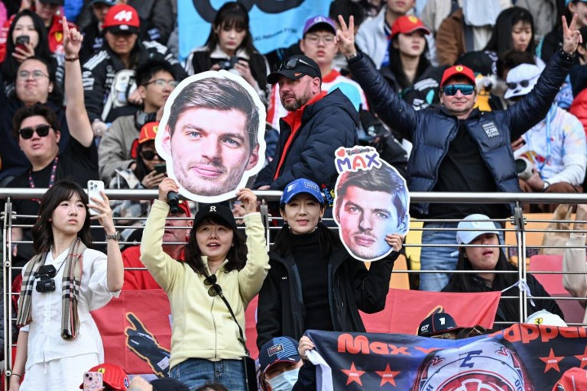 Supporters cheers with cut-outs of Red Bull Racing's Dutch driver Max Verstappen prior to the Formula One Chinese Grand Prix at the Shanghai International Circuit in Shanghai on March 15, 2026. Greg Baker / AFP