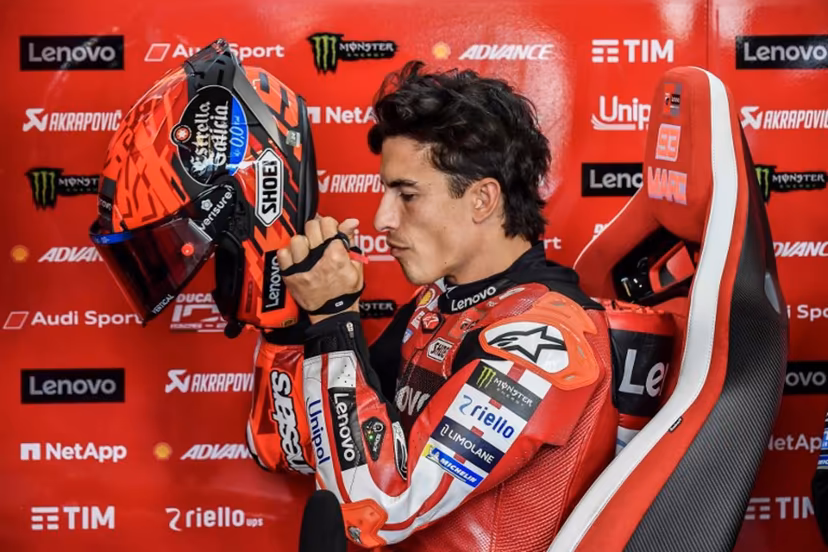 Ducati Lenovo Team's Marc Marquez puts on his helmet prior to the Practice session at the Balaton Park Circuit in Balatonfokajar, Hungary, on June 5, 2026, ahead of the Hungarian Motorcycle MotoGP Grand Prix. FERENC ISZA / AFP